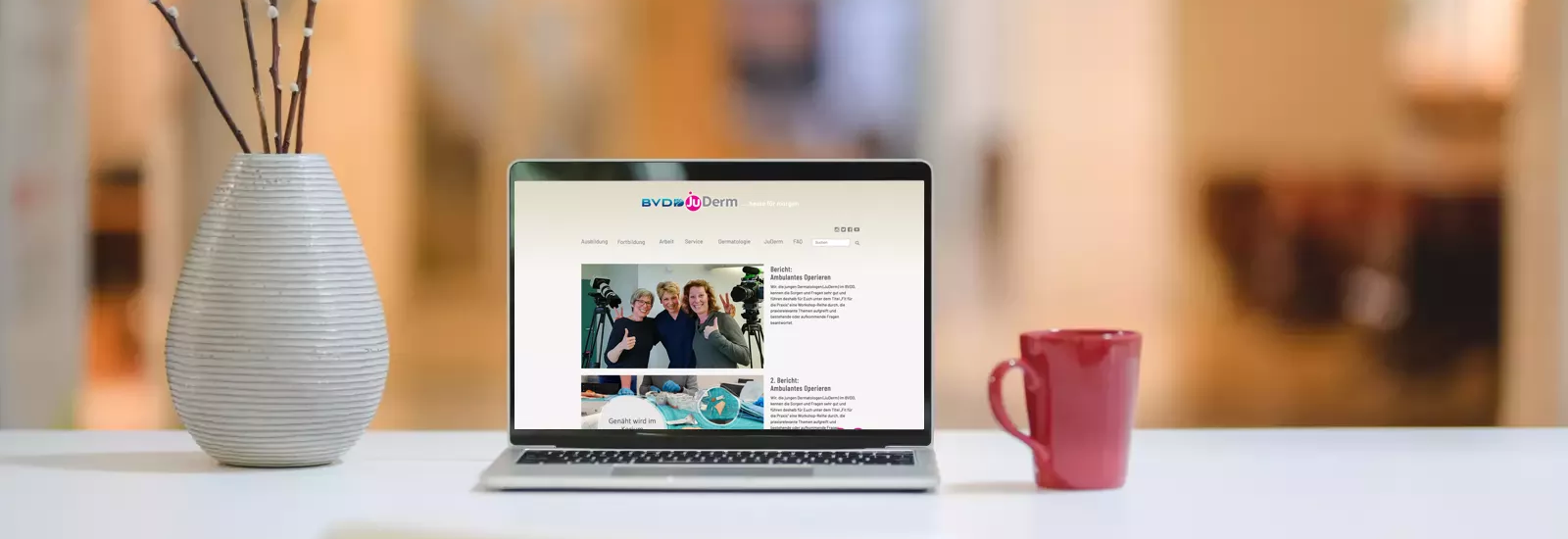 Symbol-Foto Schreibtisch mit Notebook vor unscharfem Hintergrund