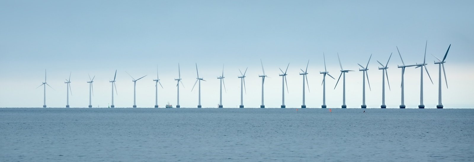 Mehrere Offshore-Windkraftanlagen am Horizont auf dem Meer vor der dänischen Küste